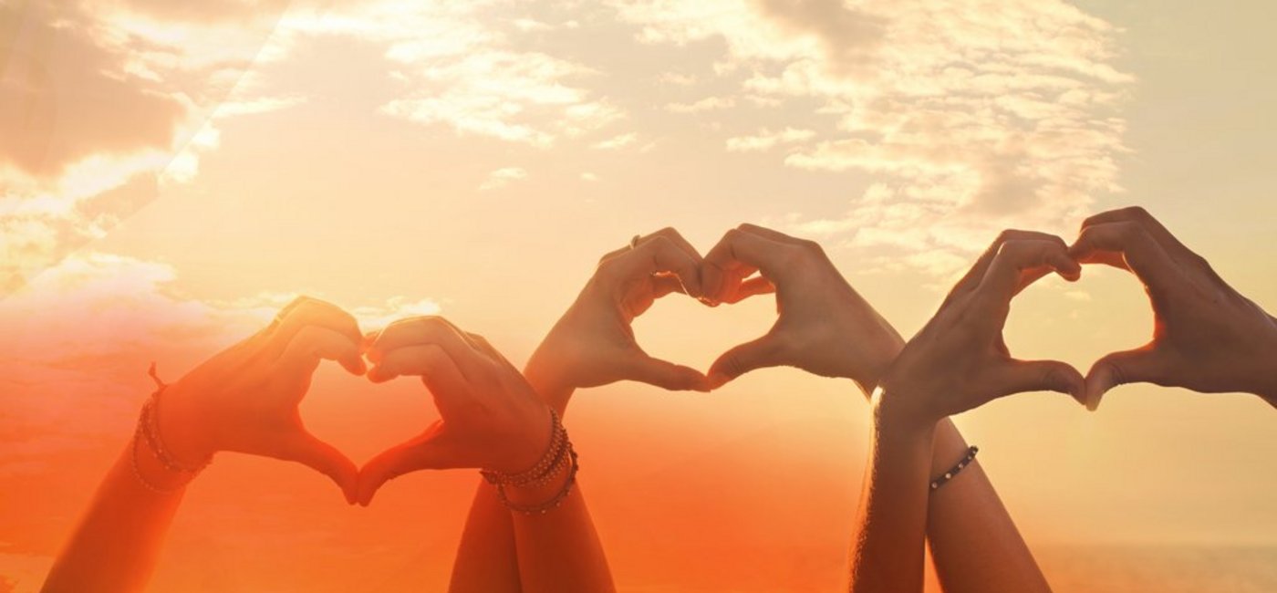 three hands of a heart-shaped woman hurled into the sky at sunse